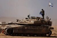 1763248914139-tentara-israel-berdiri-di-atas-tank-militer-yang-disiagakan-di-perbatasan-gaza-1755770598074_169